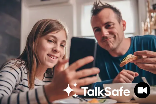 A father and daughter looking at a phone together