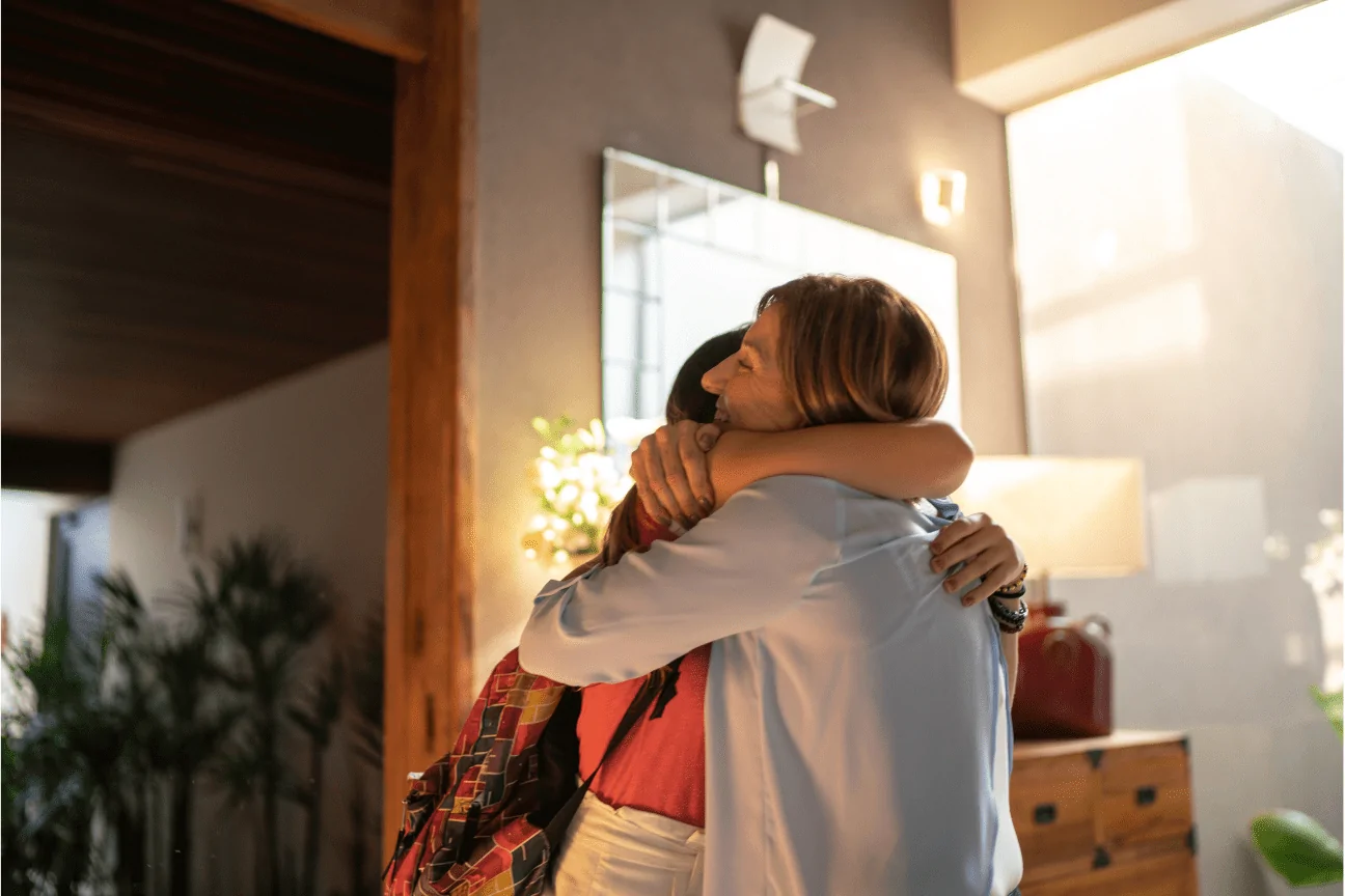 A parent and child embracing at home